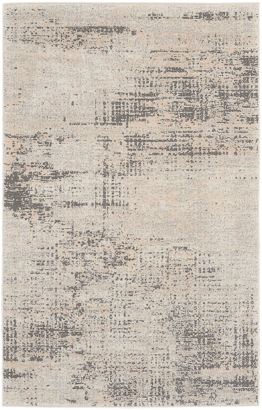 Abstract distressed beige and gray area rug with muted tonal patches for a modern living room.
