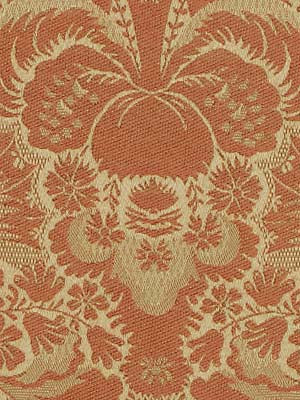 Rust-orange & cream damask upholstery fabric with ornate scrolling floral motif, vintage textile style.