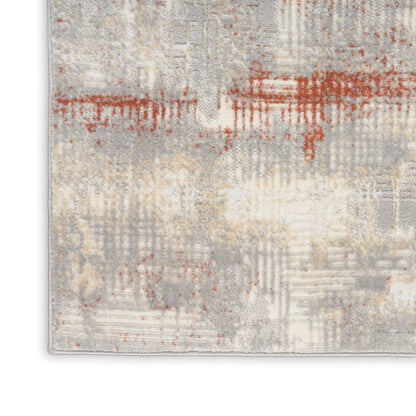 Abstract area rug in gray, beige and cream with rust-orange brush-stroke accents; soft textured pile.