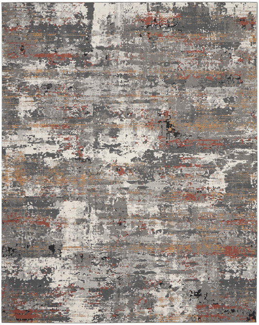 Abstract distressed area rug with gray, charcoal, white and rust-orange blocks in a modern, textured design.