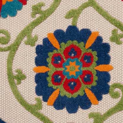 Round rug featuring a circular floral mandala pattern with blue petals, orange accents, and a red and green center on a beige lattice background.