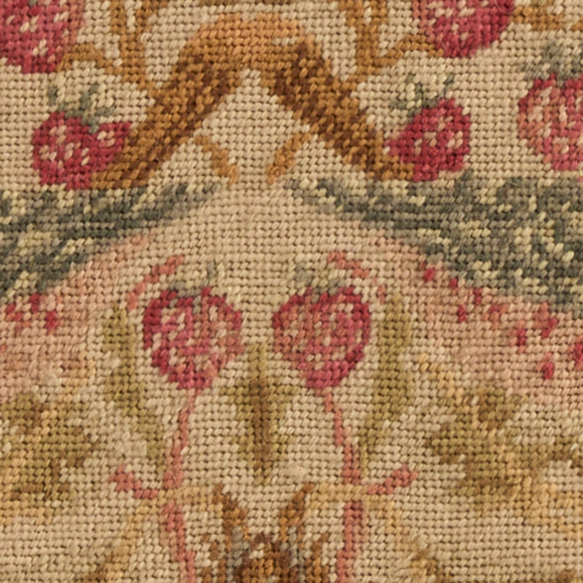 Beige woven tapestry rug with pink floral damask pattern, gold-brown scrolls and muted green accents.