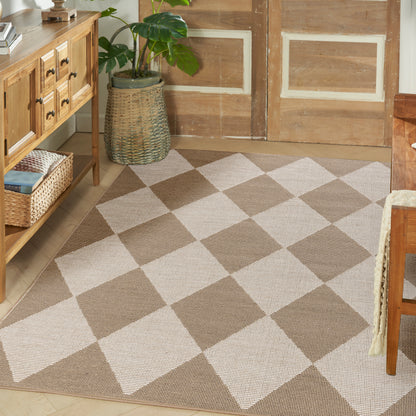 Diamond-check beige-brown woven area rug on wood floor with a wicker plant basket and wooden console in entryway.
