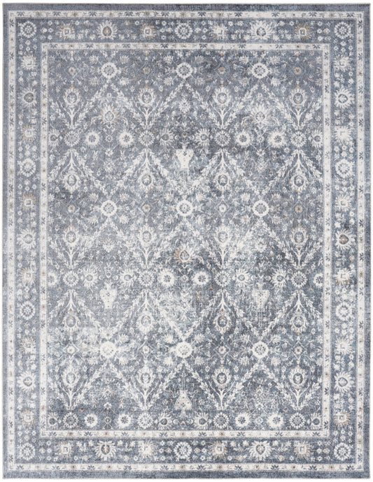 Rectangular blue-gray and ivory oriental rug with distressed floral lattice and decorative border.