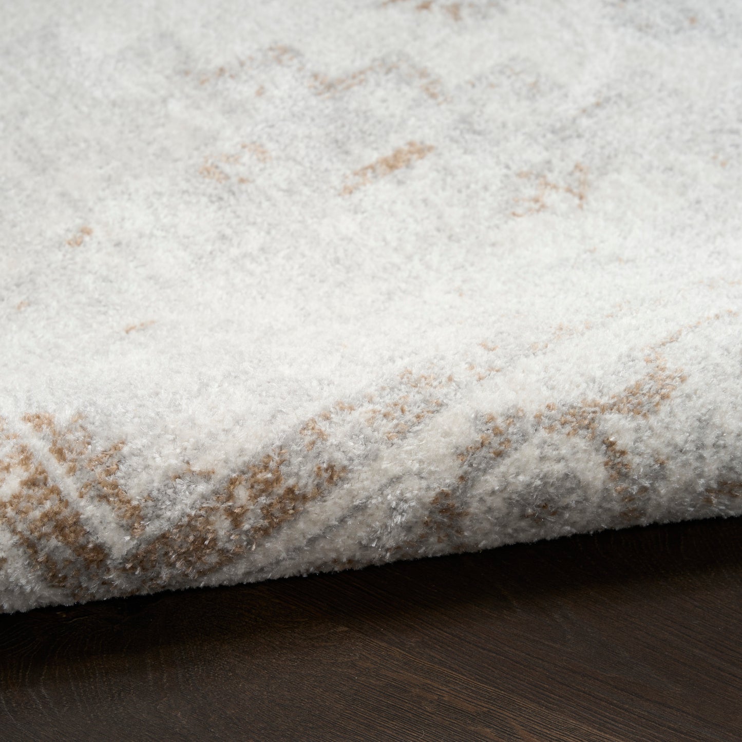 Cream shag runner with subtle beige geometric pattern, plush pile on dark wood floor.