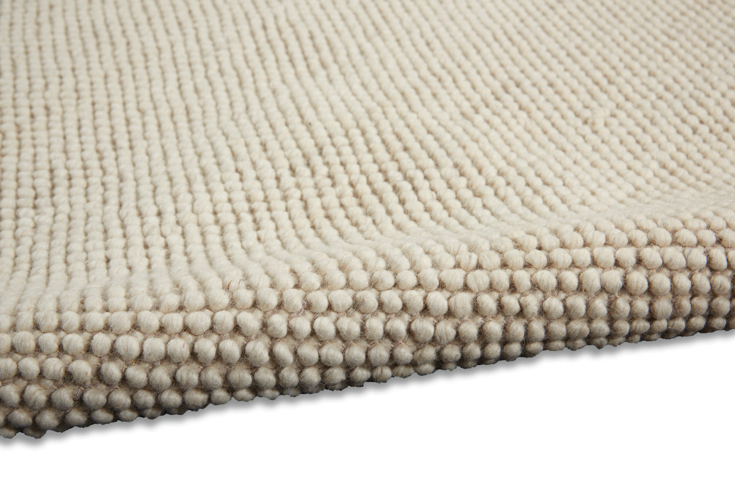Beige textured rug with dense looped pile and beaded edge, plush and cozy.