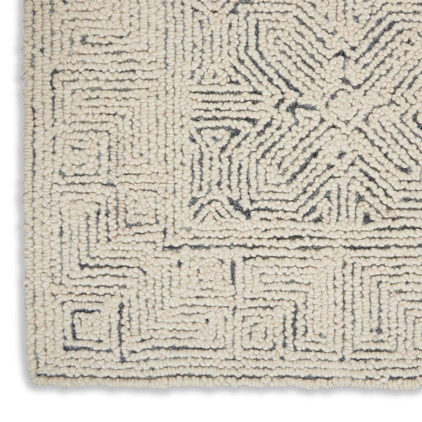 Cream boucle rug with navy geometric maze motif; plush tufted pile, rectangular modern decor.