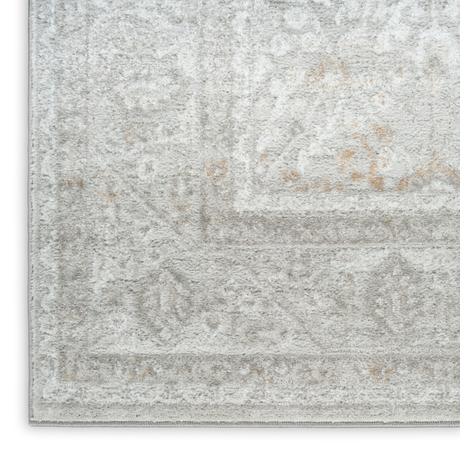Light gray distressed rug with subtle cream patterns and vintage-inspired border.