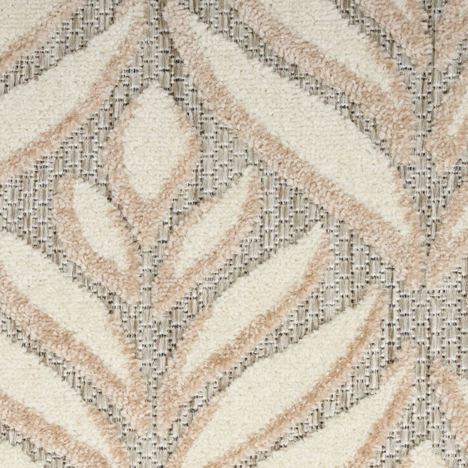 Cream & beige shag rug with abstract leaf pattern in taupe & gray, soft textured pile.