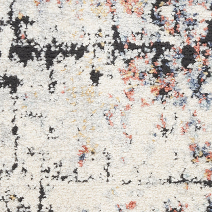 Soft cream abstract area rug with black, orange-pink and blue speckles; plush high-pile texture.