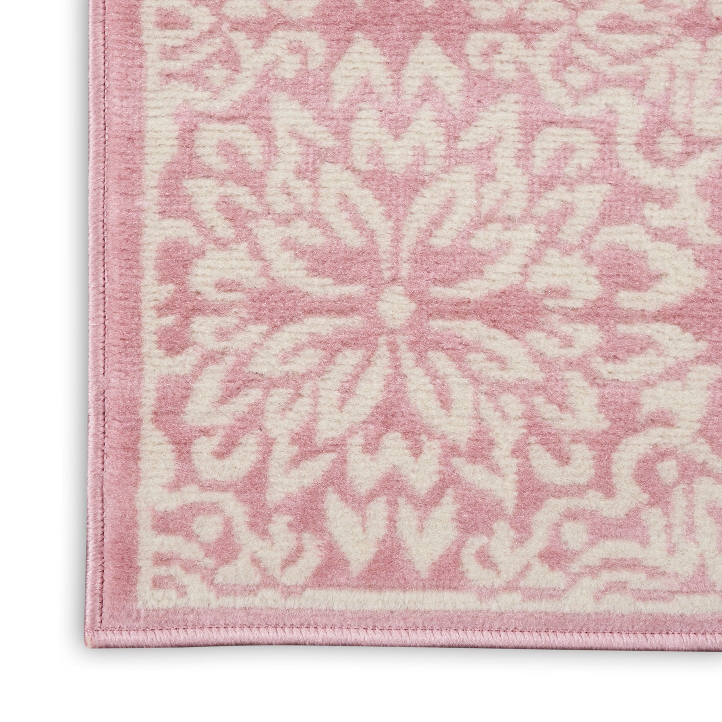 Rectangular soft pink plush rug with pale pink floral mandala pattern and bound edge.
