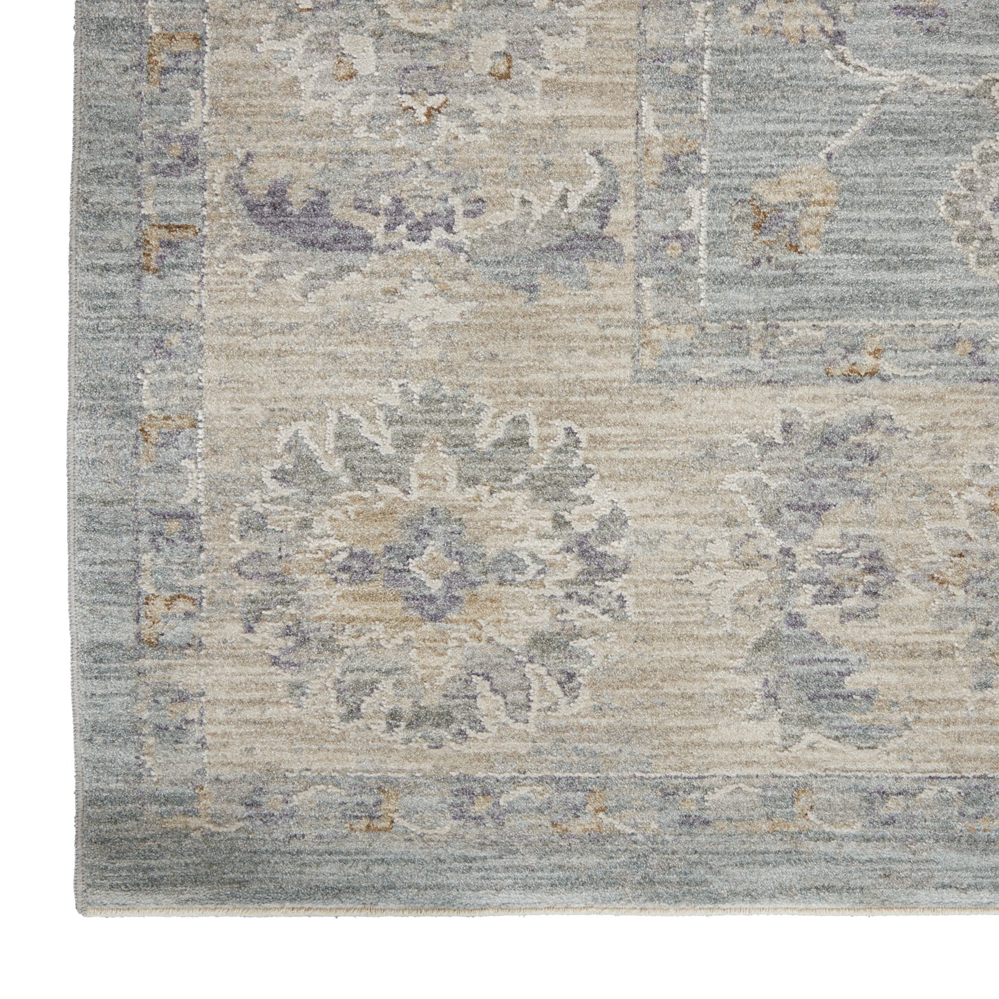 Blue-gray vintage-inspired rug with faded beige floral medallions and decorative border.