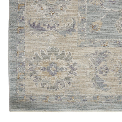 Blue-gray vintage-inspired rug with faded beige floral medallions and decorative border.