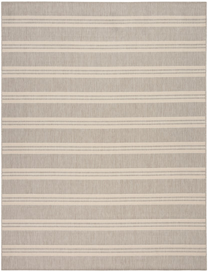 Beige textured rug with cream horizontal stripes; flat-weave, neutral coastal style.