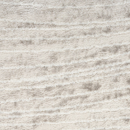 Beige cream plush rug with soft, wavy texture; cozy living room carpet.