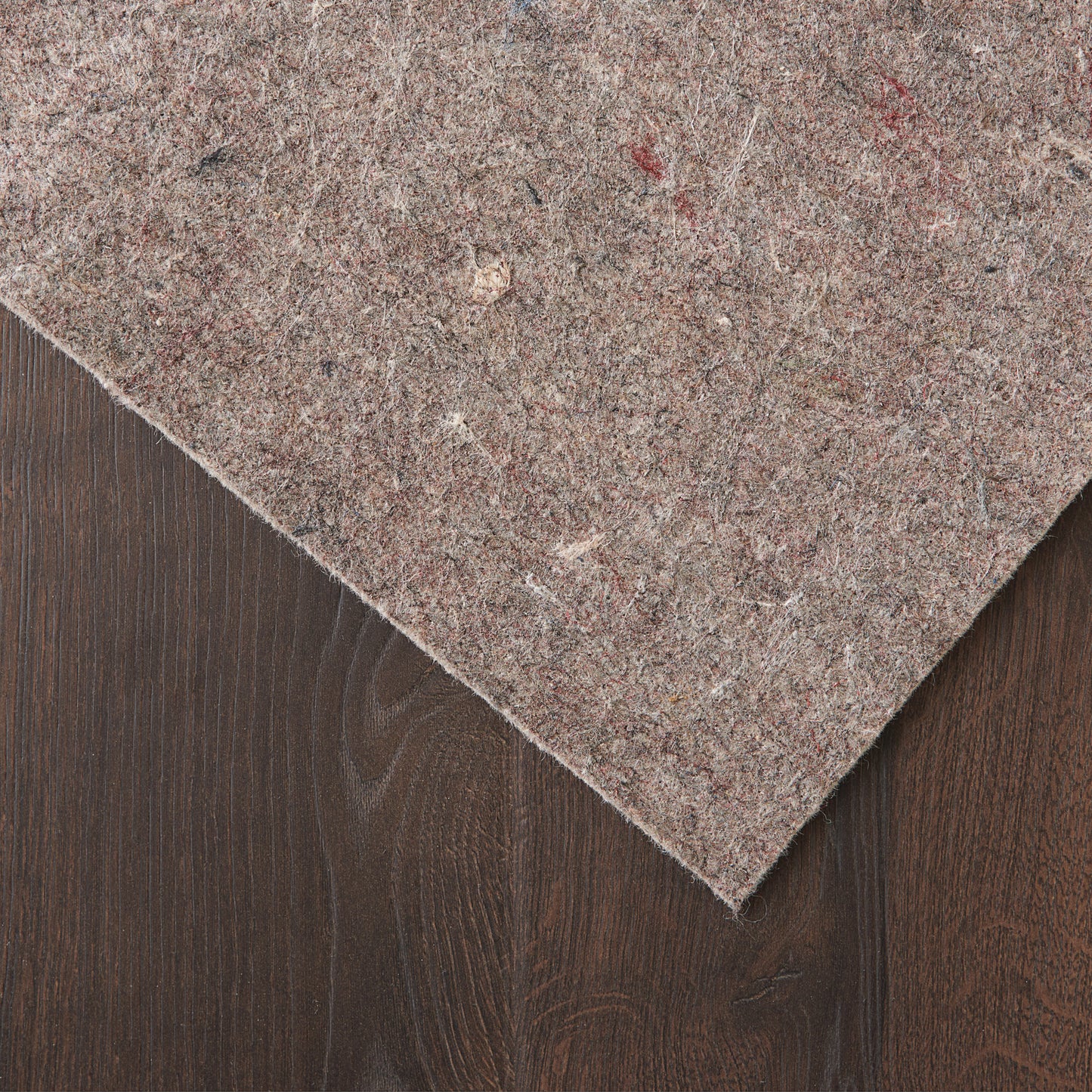 Brown speckled rug runner on dark wood surface; soft, textured fabric.