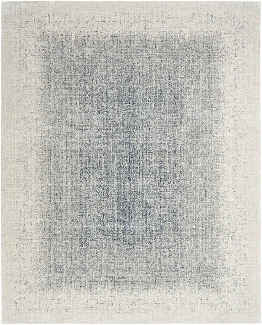 Rectangular woven area rug with a distressed blue-gray center on a cream-beige field; vintage abstract texture.