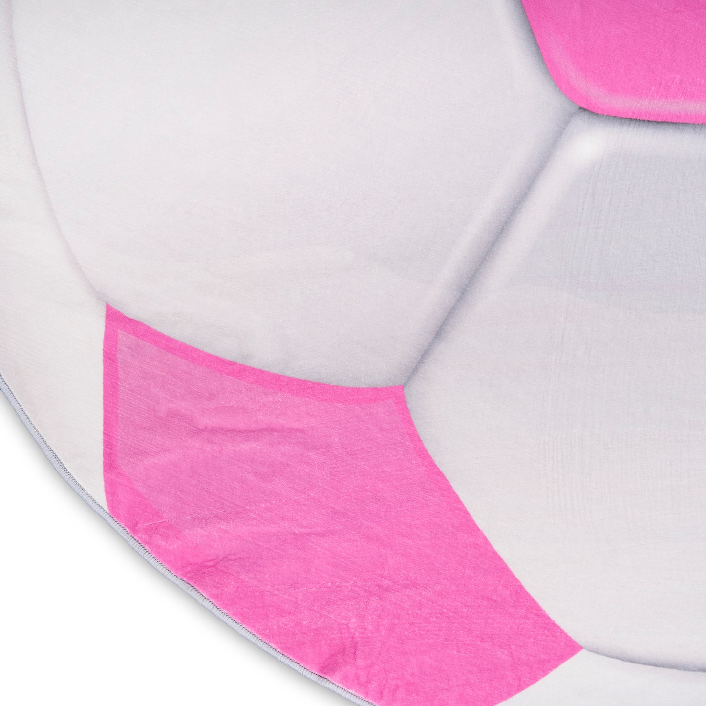 Close-up of a round pink and light gray fabric cushion with panel seams.