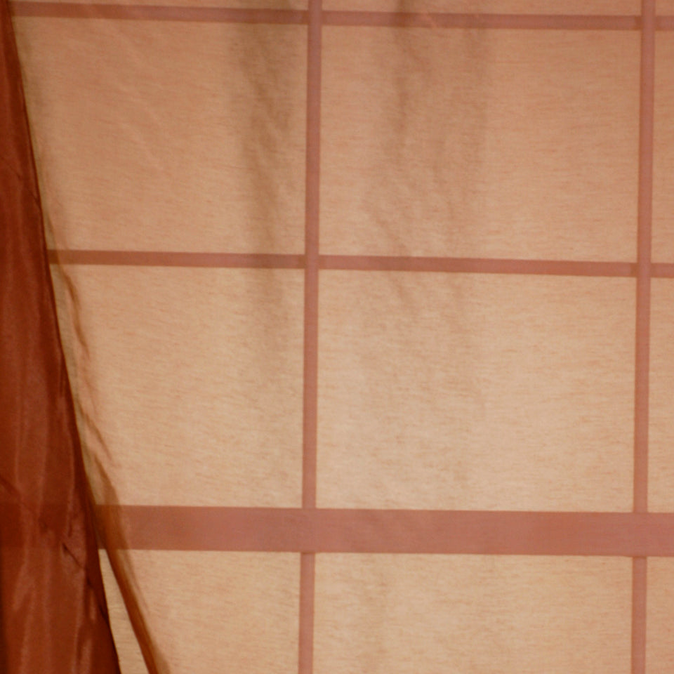 Beige drapery fabric with a brown grid pattern, warm earthy tones.