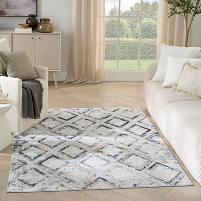 Diamond-pattern blue-gray area rug in a neutral living room with cream sofa.