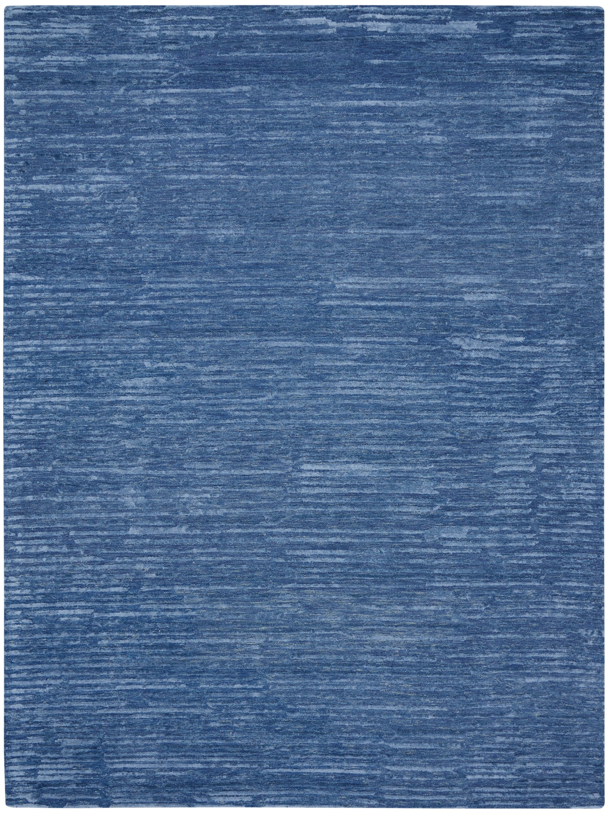 Blue textured area rug with subtle lighter blue brushstroke pattern and rounded corners.