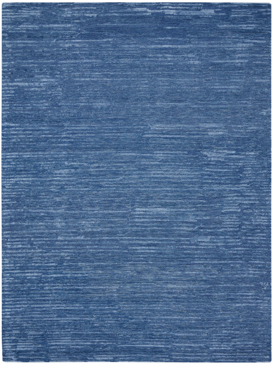 Blue textured area rug with subtle lighter blue brushstroke pattern and rounded corners.