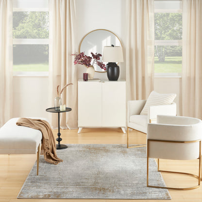Neutral living room with white cabinet, round mirror, black lamp, pink flowers; beige curtains, cream chairs on gray rug.
