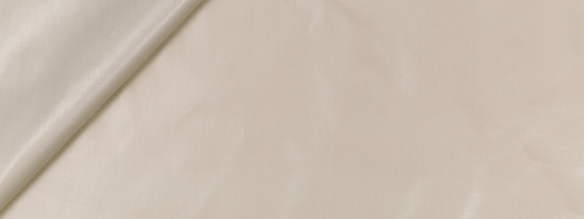 Beige linen fabric with subtle texture and a folded edge, soft and lightweight drape.