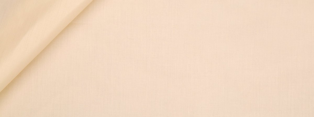 Beige linen-like fabric with gentle fold, smooth textile in warm neutral tone