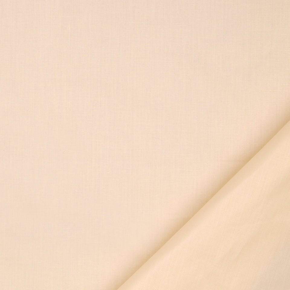 Cream fabric close-up with a diagonal fold in the bottom-right, soft neutral textile texture.
