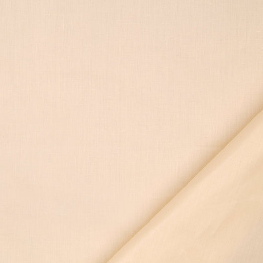 Cream fabric close-up with a diagonal fold in the bottom-right, soft neutral textile texture.