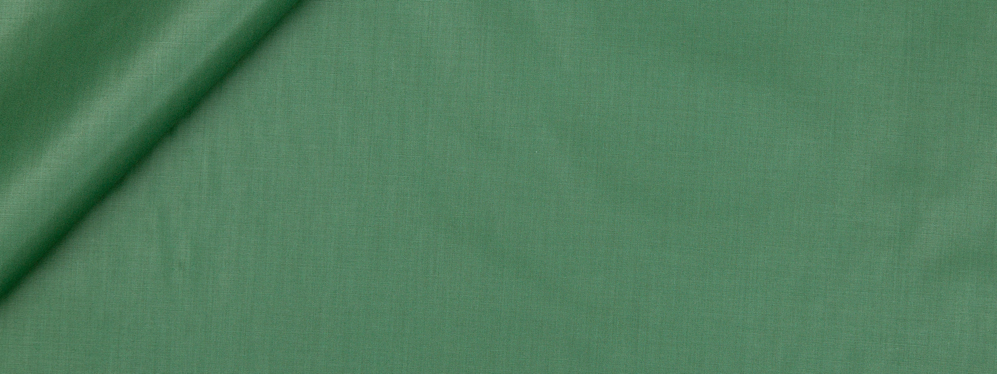 Emerald green fabric with a subtle weave and diagonal fold; versatile for sewing projects.