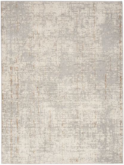 Rectangular abstract area rug in pale gray and beige with a distressed patchwork pattern and copper accents.