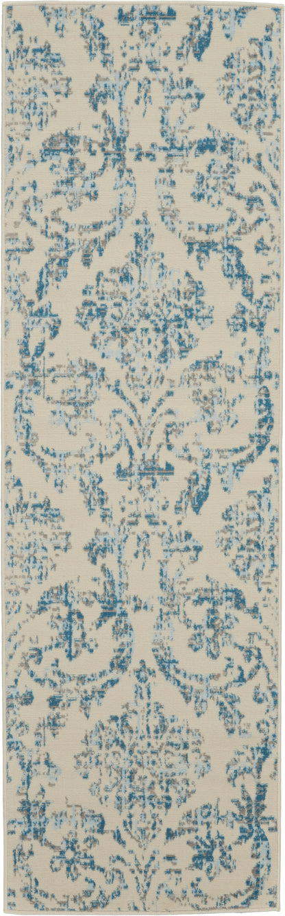 Cream-colored rectangular runner rug with blue distressed damask pattern and ornate floral motifs.