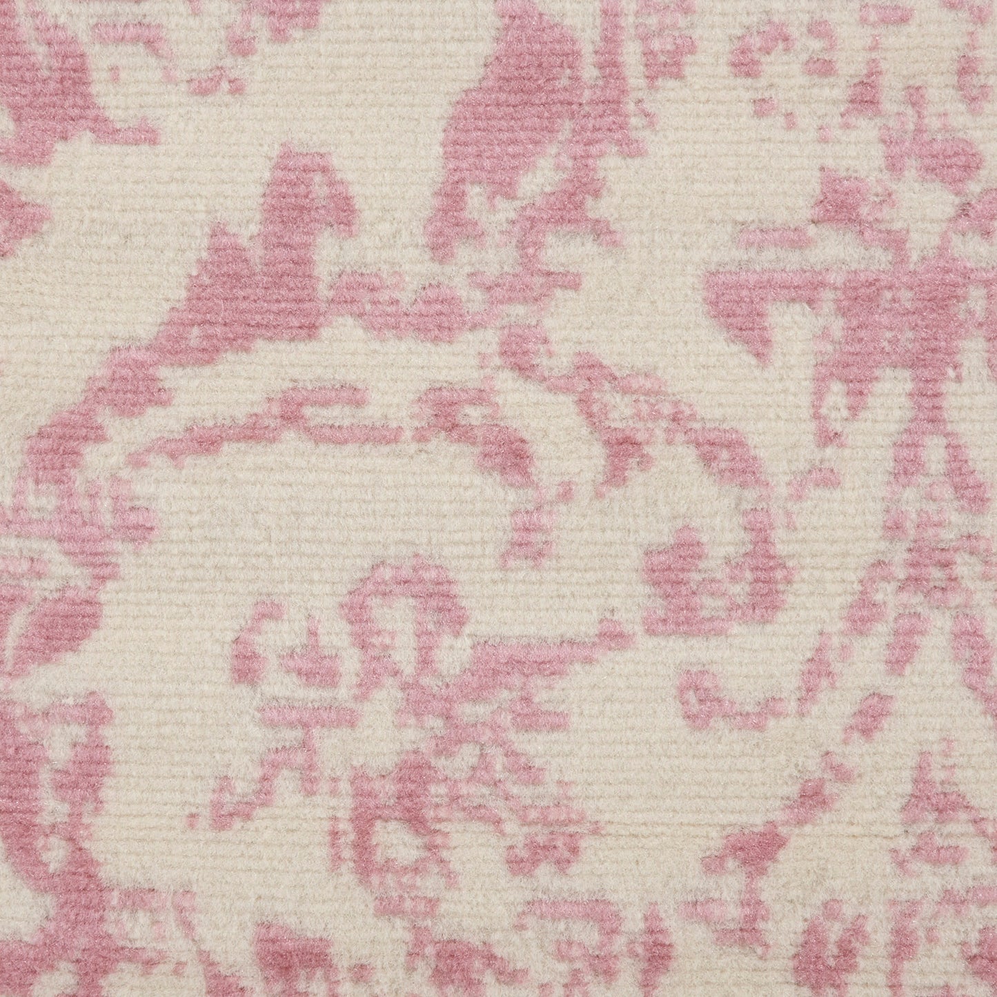 Close-up of pink damask motif on cream rug; jacquard-style weave with ornate floral scrolls, vintage elegance, 2' x 4'.