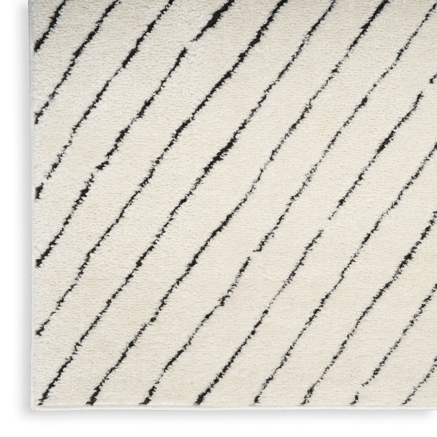 Cream shag rug with diagonal black lines, soft textured pile; rectangular area rug.