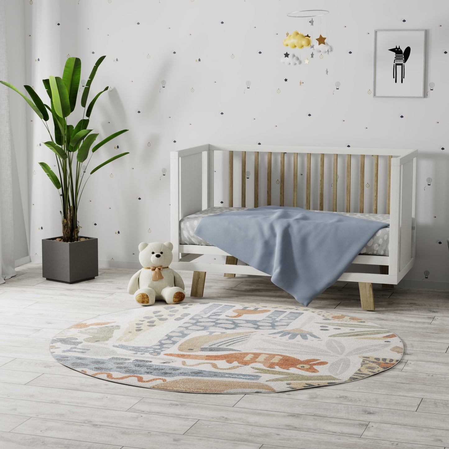 Nursery scene with a white wooden crib, light blue blanket, round pastel rug, plush bear, tall plant, wall decals and framed art.