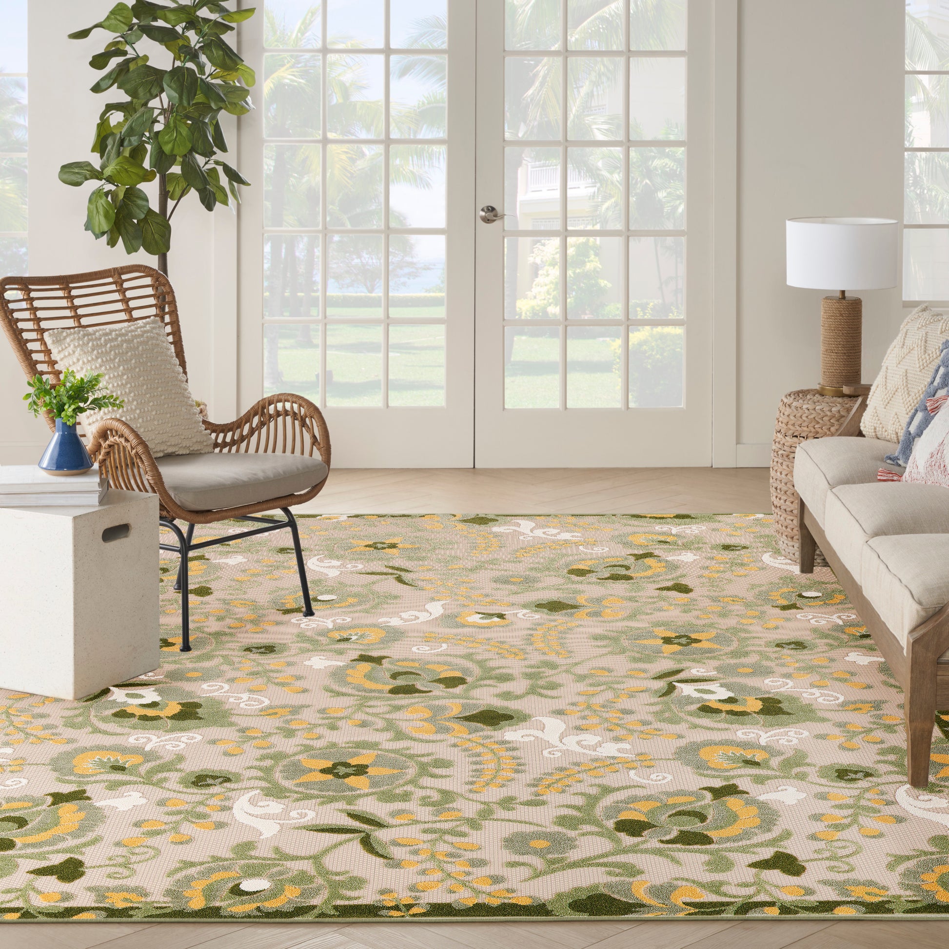 Floral area rug in beige with yellow, green, and white blossoms; modern boho living room setup.