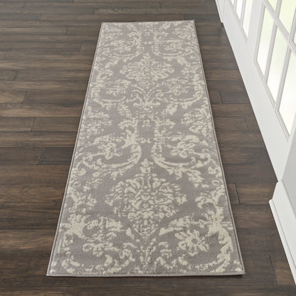 Gray runner rug with ivory damask pattern and pale border, ideal for a hallway.