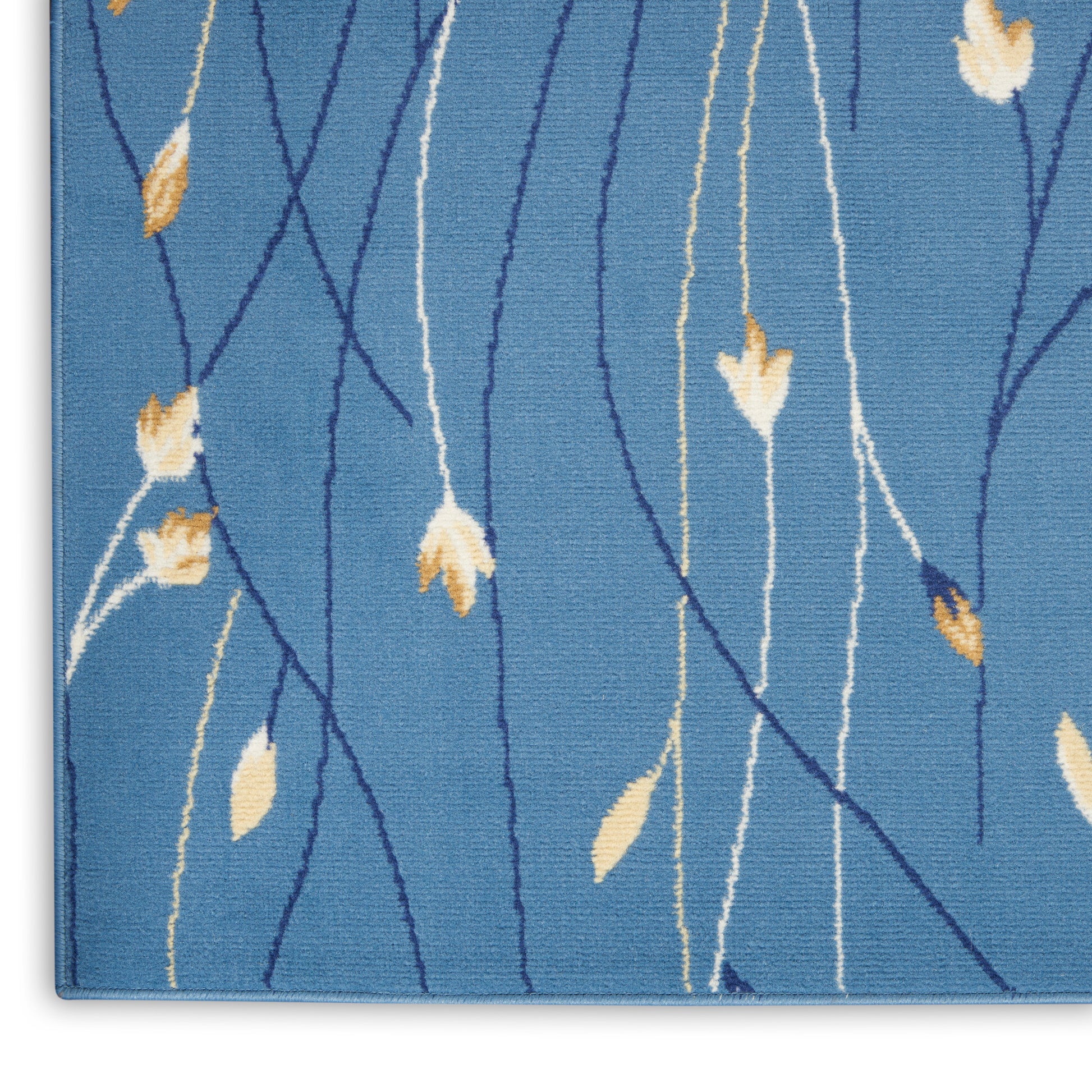 Blue textured area rug with intertwining navy and cream lines and beige leaf accents.