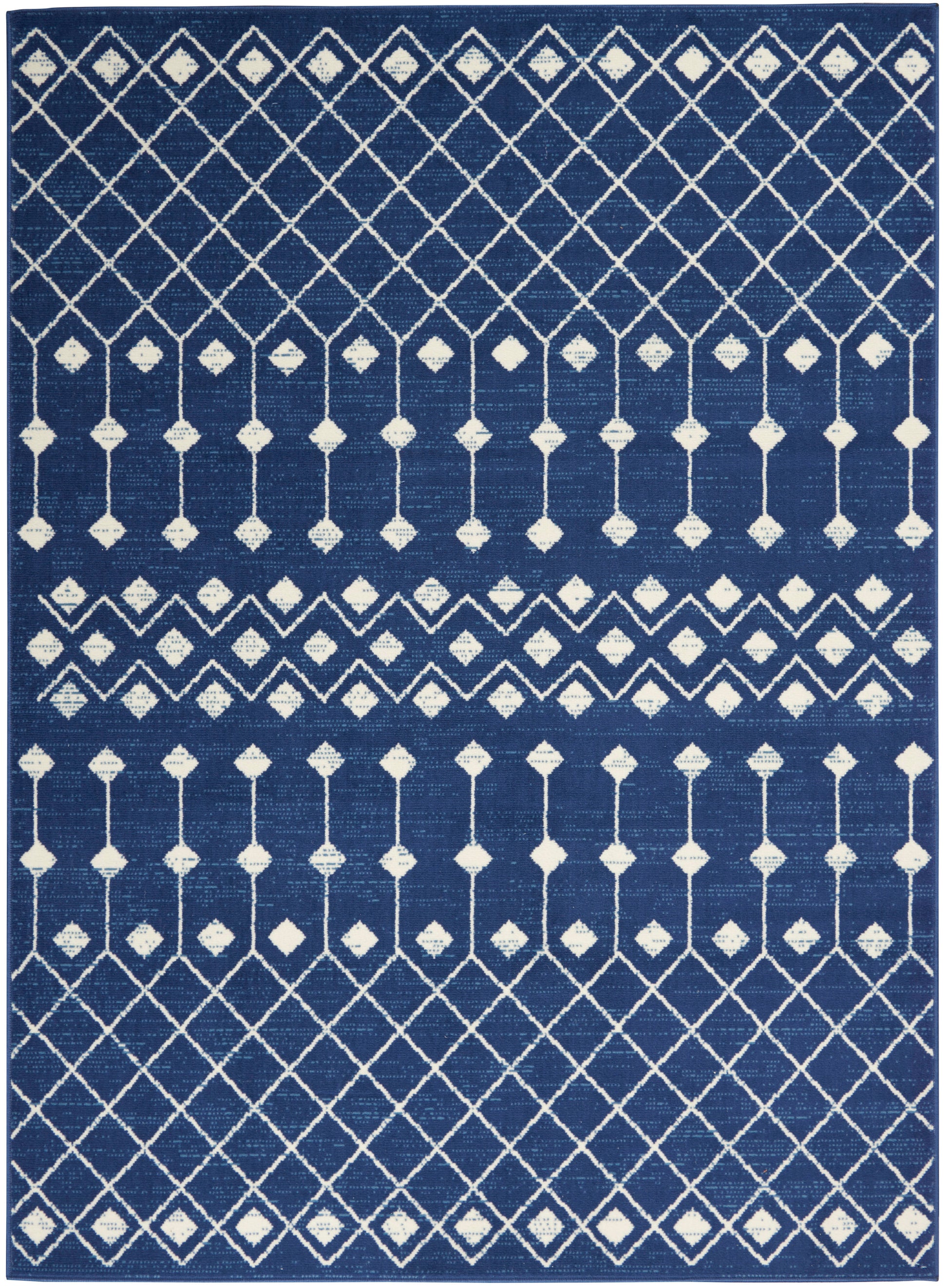 Navy blue rectangular rug with white diamond lattice and vertical line motifs in a geometric pattern.