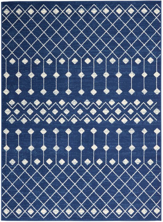 Navy blue rectangular rug with white diamond lattice and vertical line motifs in a geometric pattern.