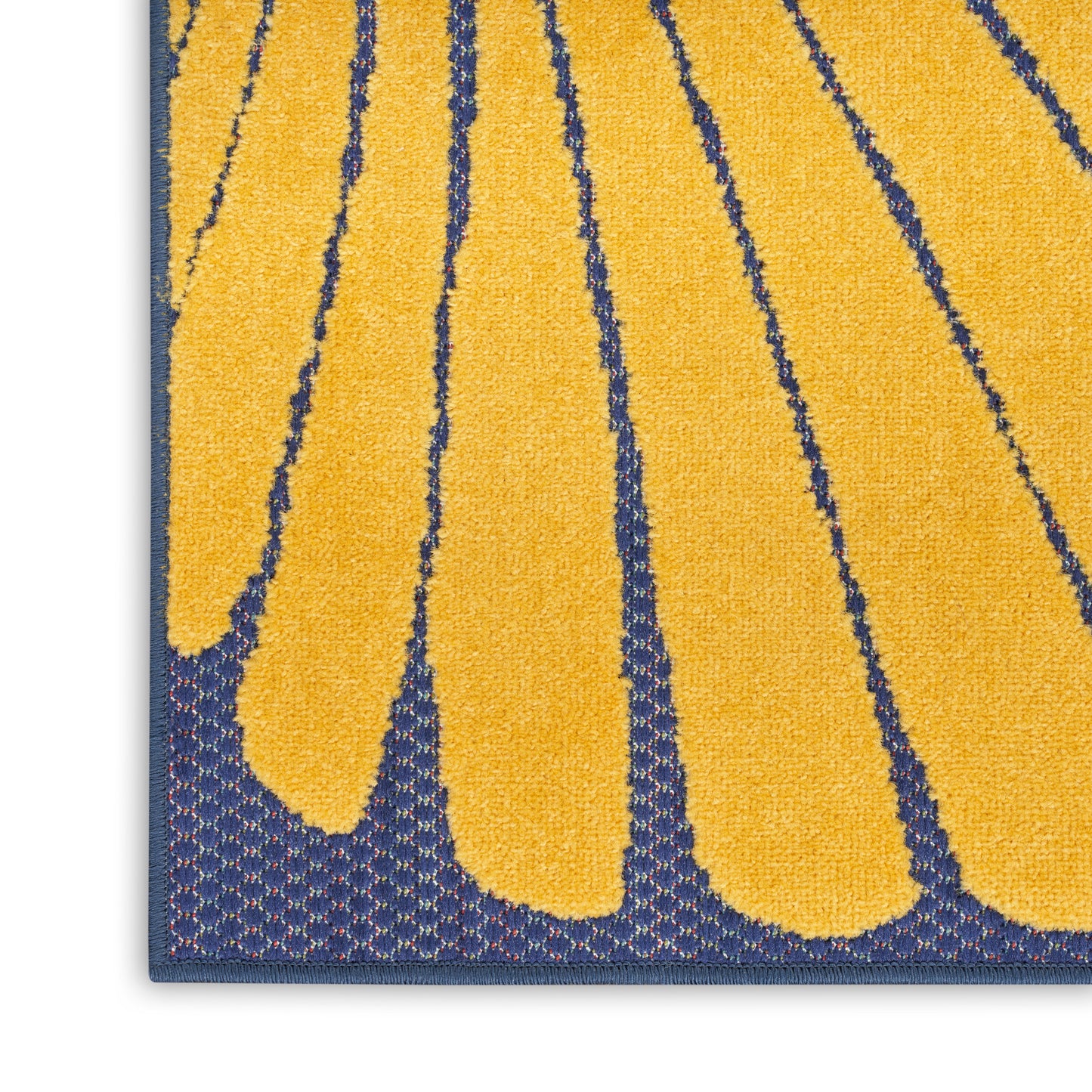 Close-up of a navy rug featuring bold yellow petal shapes and a blue border, tufted texture.