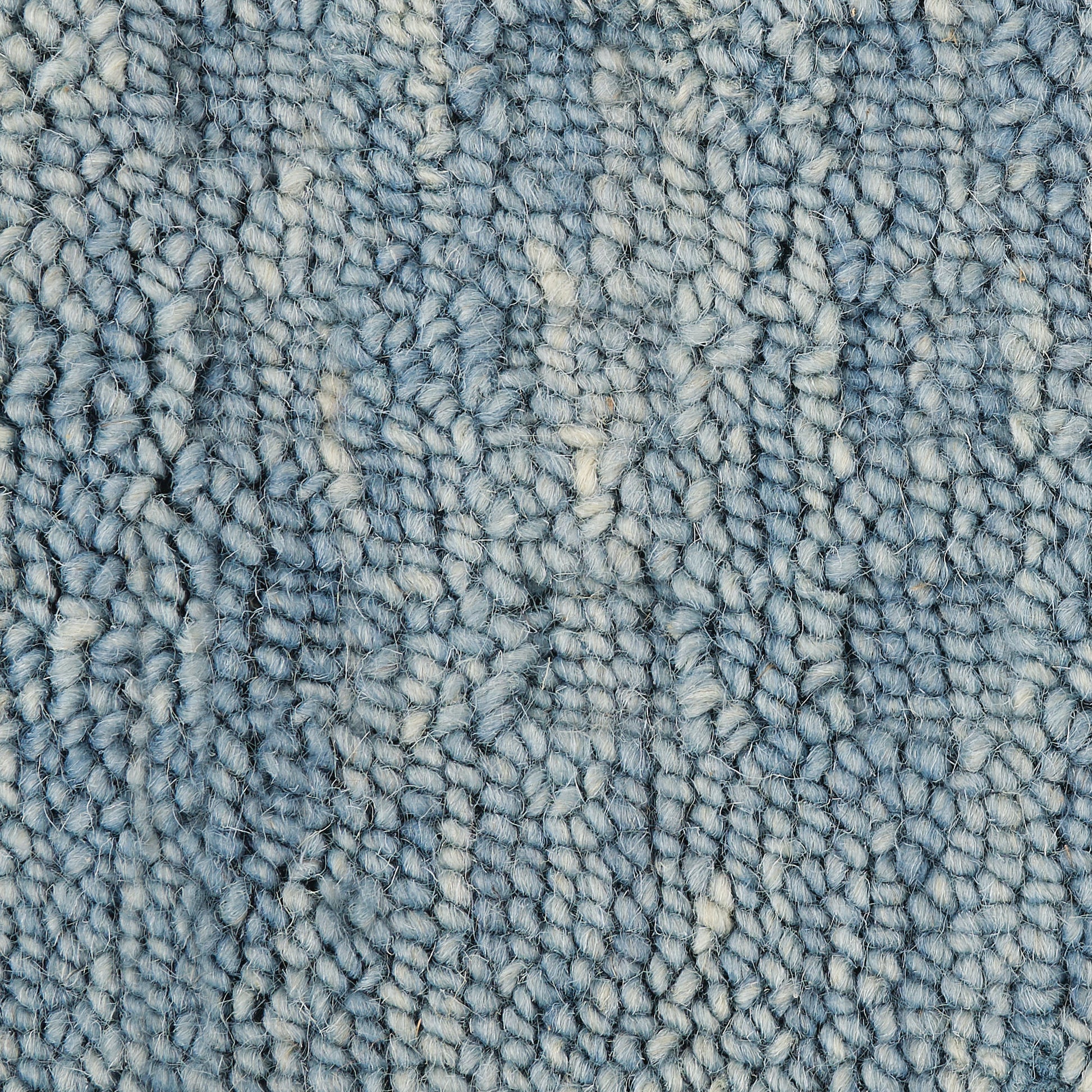 Blue boucle runner rug close-up showing soft loop pile with cream specks and varied blue tones.