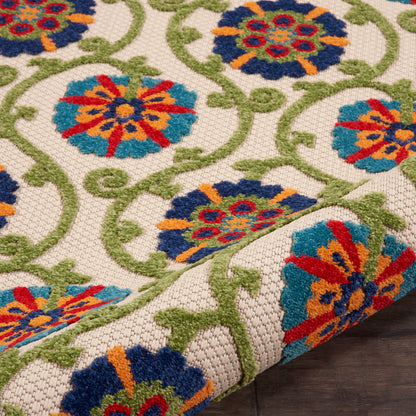 Colorful woven area rug with blue, teal, orange and red floral medallions on ivory background and green scrolling vines.