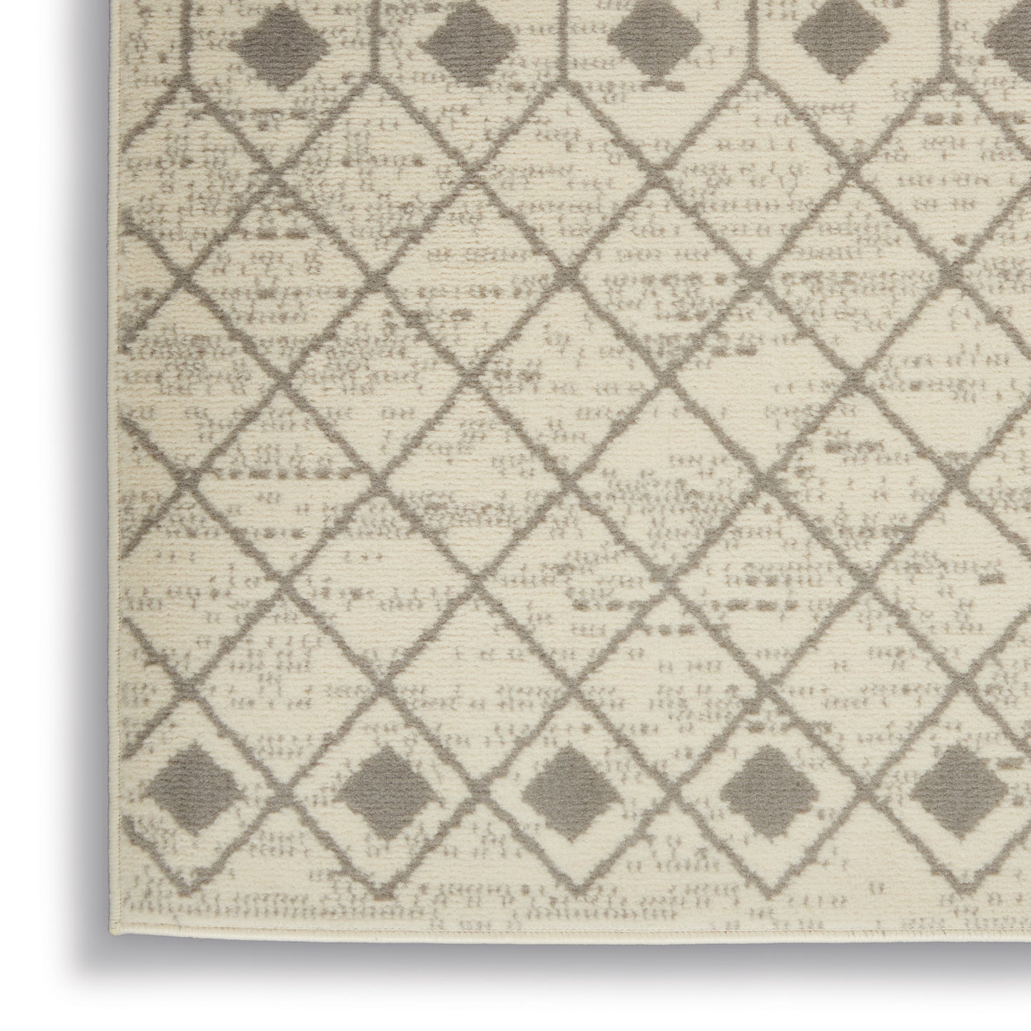 Beige woven rug with taupe diamond lattice pattern and small square accents; neutral geometric style for living spaces.