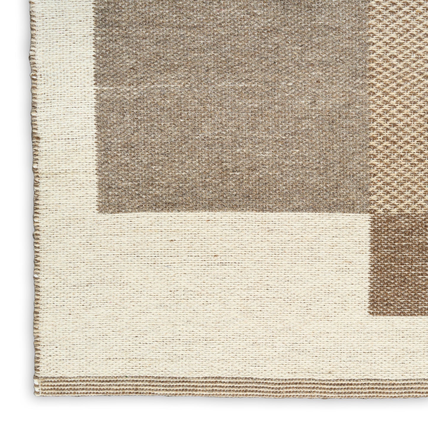 Rectangular woven rug with cream base and beige-brown blocks; textured weave and bordered edges.
