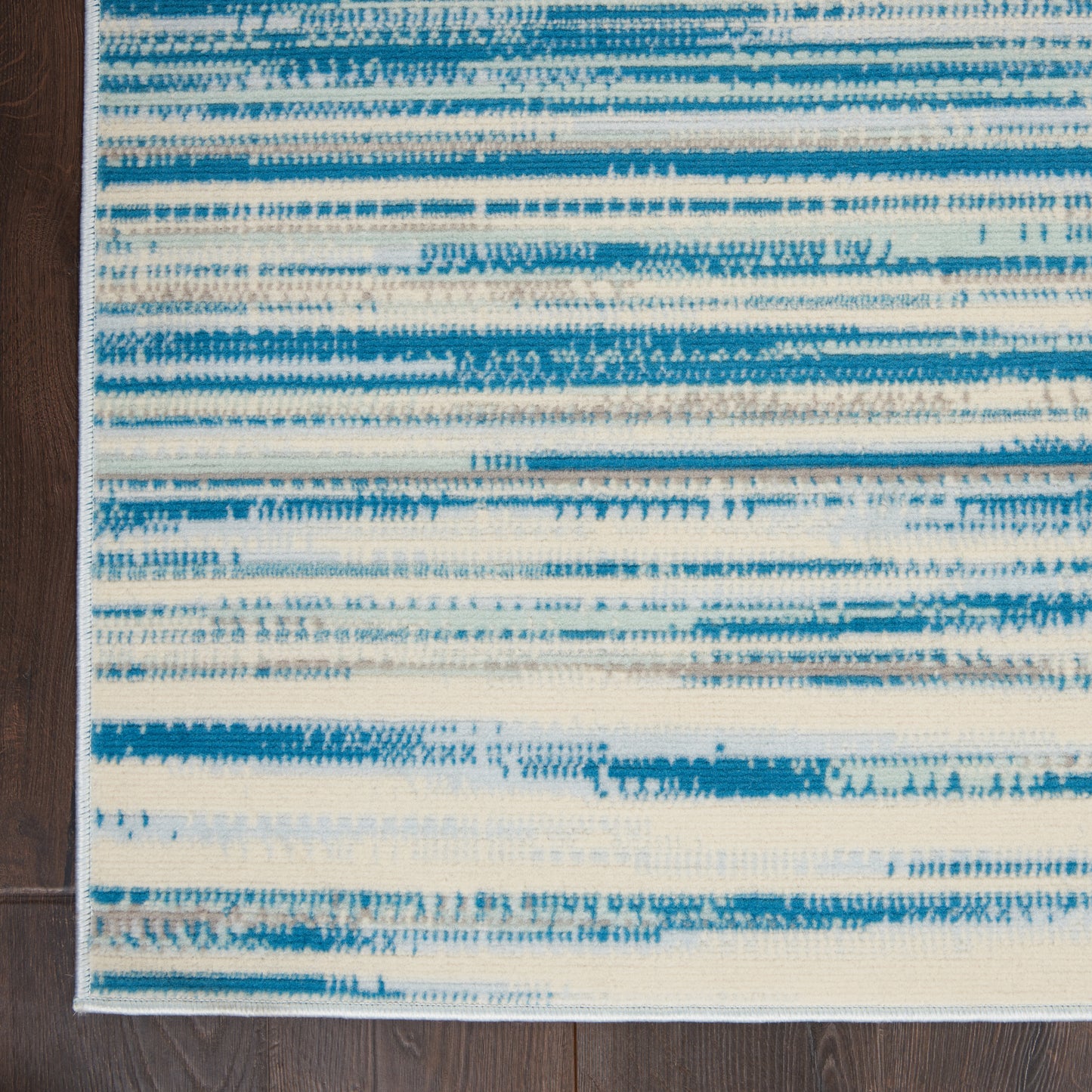 Blue and white abstract striped woven rug, low-pile, contemporary coastal style for living room, 5' x 7'.