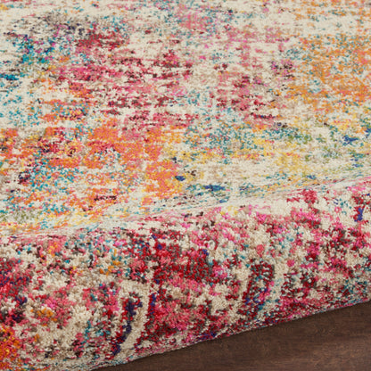 Colorful shaggy area rug with abstract splashes of pink, yellow, blue, orange on cream, shown on dark hardwood floor.
