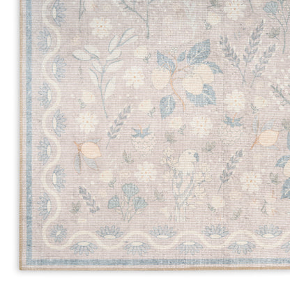 Pastel floral area rug with pale pink background, blue flowers and vines, and a light blue border.